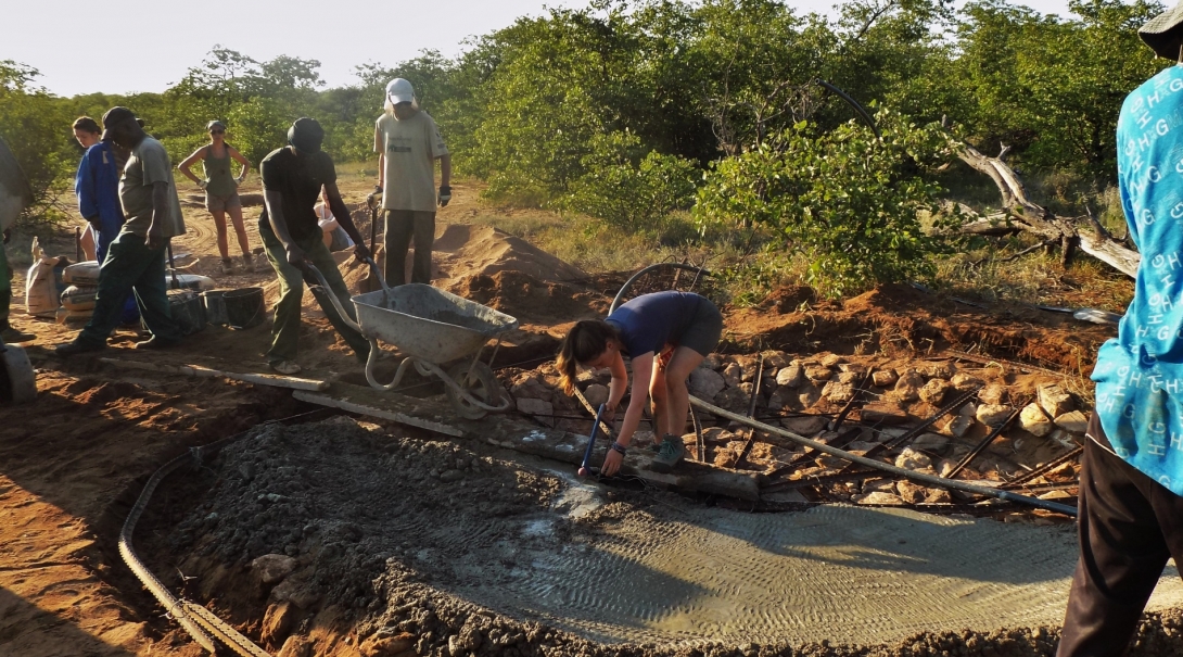 Transition Year volunteers help build a waterhole for wild animals during a drought in Botswana. A group of volunteers work to dig a waterhole to help animals during drought season during their Transition Year in Africa.